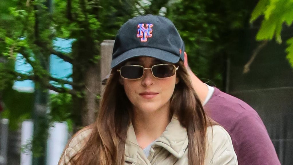 Dakota Johnson’s effortless style: jeans, trainers, and padded jacket for a polished spring look.