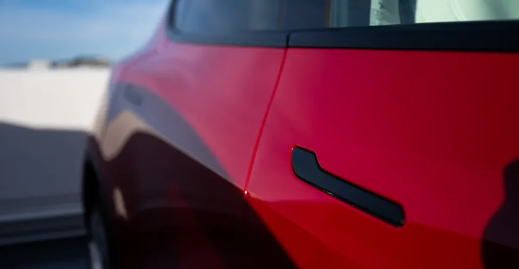 Difetto nelle porte delle auto Tesla potrebbe innescare regole più severe per l’intero settore.