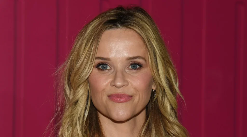 Reese Witherspoon’s chic white dress and cowboy boots for a stylish transition to fall.
