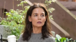 Katie Holmes demonstrates why flat boots elevate straight-leg jeans for stylish autumn looks.
